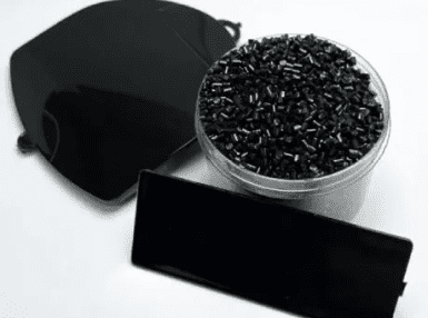 A black bag and some black beads on the table