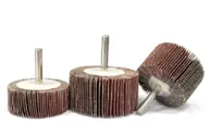 A group of three grinding wheels with a metal shaft.